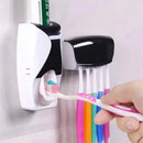 Porta escovas de parede com dispensador automático de pasta de dente, instalado sem furos, organizando escovas e creme dental em um banheiro moderno.